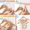Demonstration of cascading clothes hanger connector hooks used for space-saving wardrobe organization.