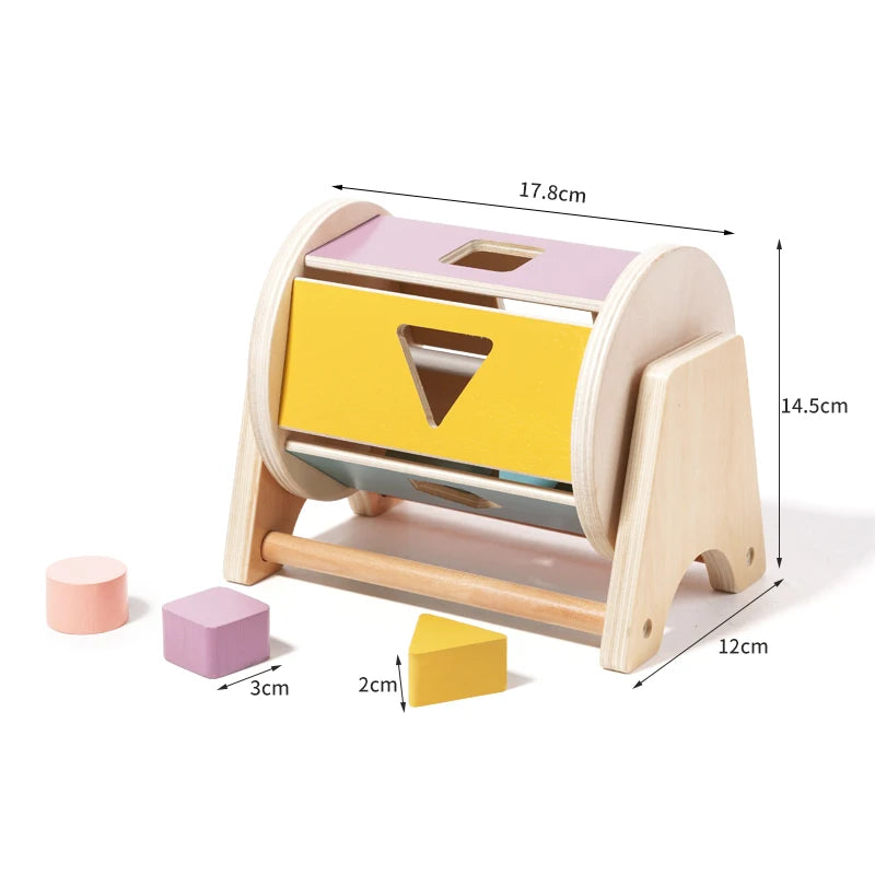 A wooden baby rattle bell with a soothing ring, featuring yellow and pink colors.