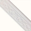 White 3D foam wall trim border sticker with decorative scrollwork applied to a surface.