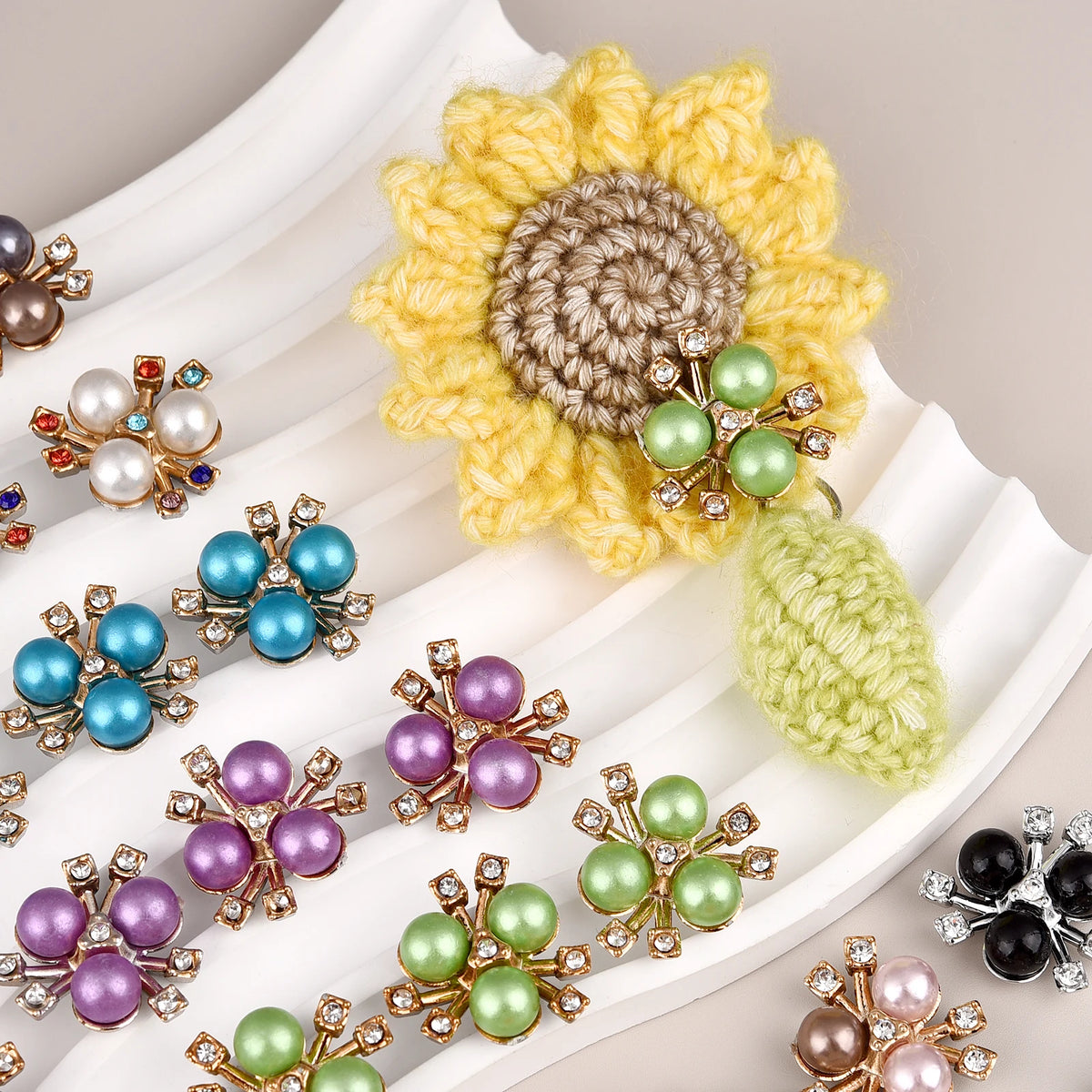 A collection of yellow and green pearlized resin flower beads used for DIY jewelry and crafts.
