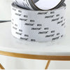 Roll of white Jimator self-adhesive fiberglass screen repair tape resting on a gold-rimmed table.