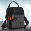 A black and gray versatile casual crossbody bag with an adjustable strap shown against a blurred city background.