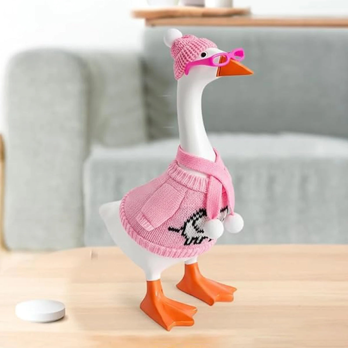 A knitted sweater and hat costume set for a desk goose statue decor featuring pink and white colors.