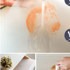 A hand is pouring water onto a white EVA waterproof non-slip drawer and shelf liner mat, causing an orange stain.