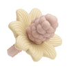 Silicone baby teether toys shaped like flowers and grapes in pale pink and cream colors.