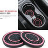 A set of two black and pink non-slip silicone car cup holder coasters shown in various angles.