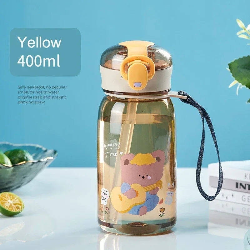 A yellow 400ml glass water bottle with a cartoon bear design and an orange leakproof lid, sitting on a white surface.