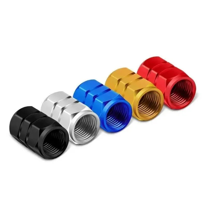A collection of colorful aluminum alloy tire valve caps in red, yellow, blue, and silver metal finishes.