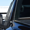 Close-up view of a black metal car antenna mounted on the side of a vehicle.