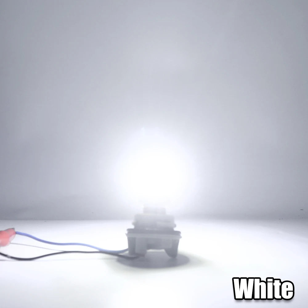 A single white LED bulb is shown on a surface, with a wire connected to it.