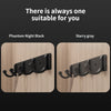 Two sets of no-drill aluminum wall hooks in Phantom Night Black and Starry gray against a wooden background.