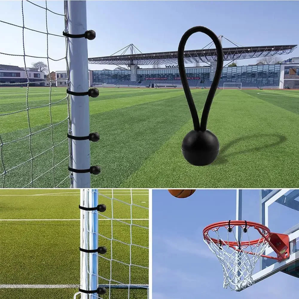 A close-up view of heavy duty bungee cords with elastic ball ends hanging from a white pole against a green field.