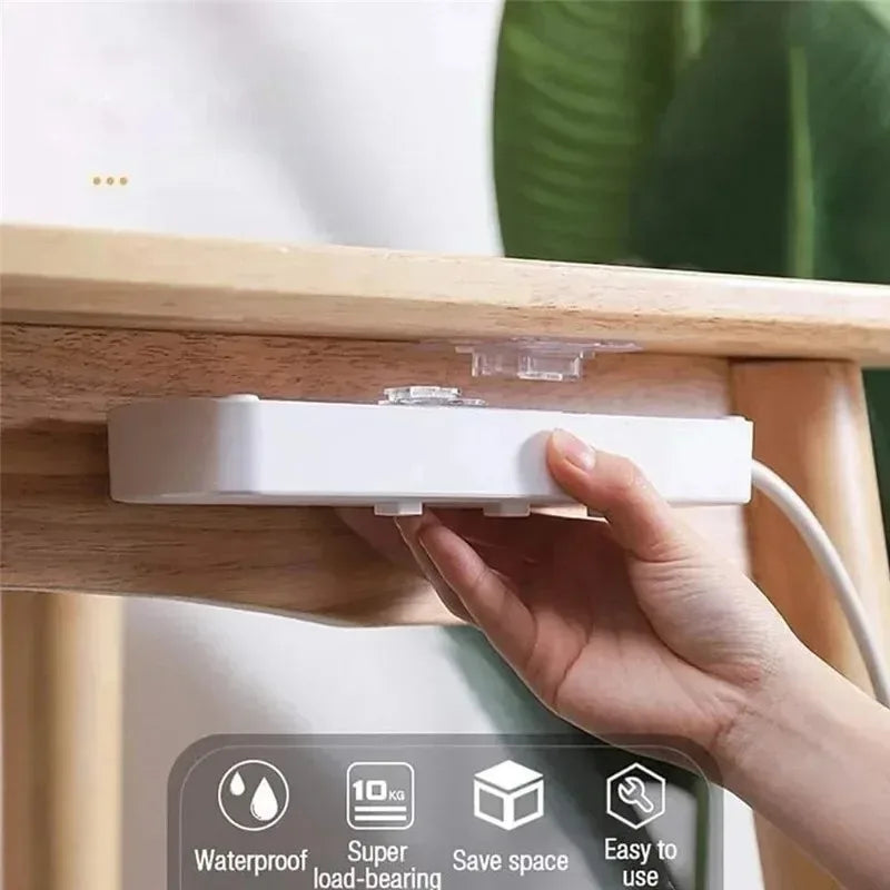 A hand is installing a white invisible adhesive hook onto a wooden surface, demonstrating its use for removable wall hooks.