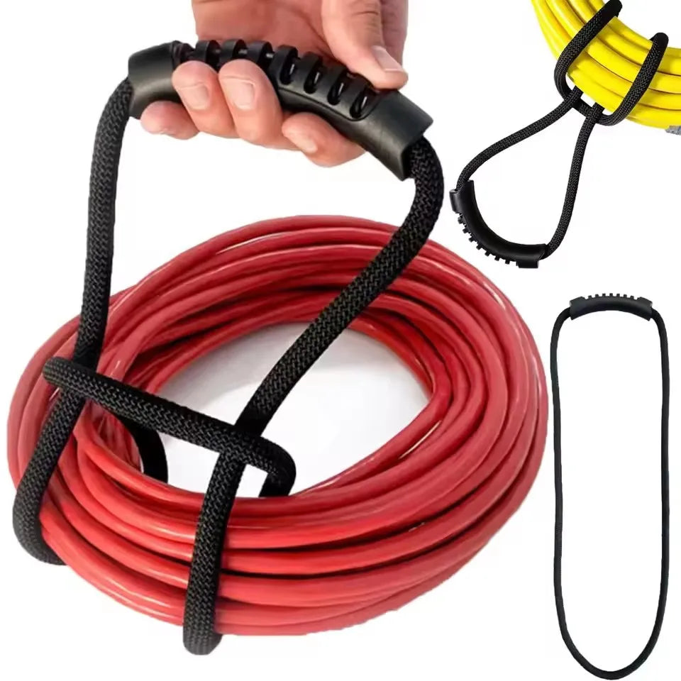 A hand is holding a black hook and loop storage strap, with coiled red straps and yellow straps visible.
