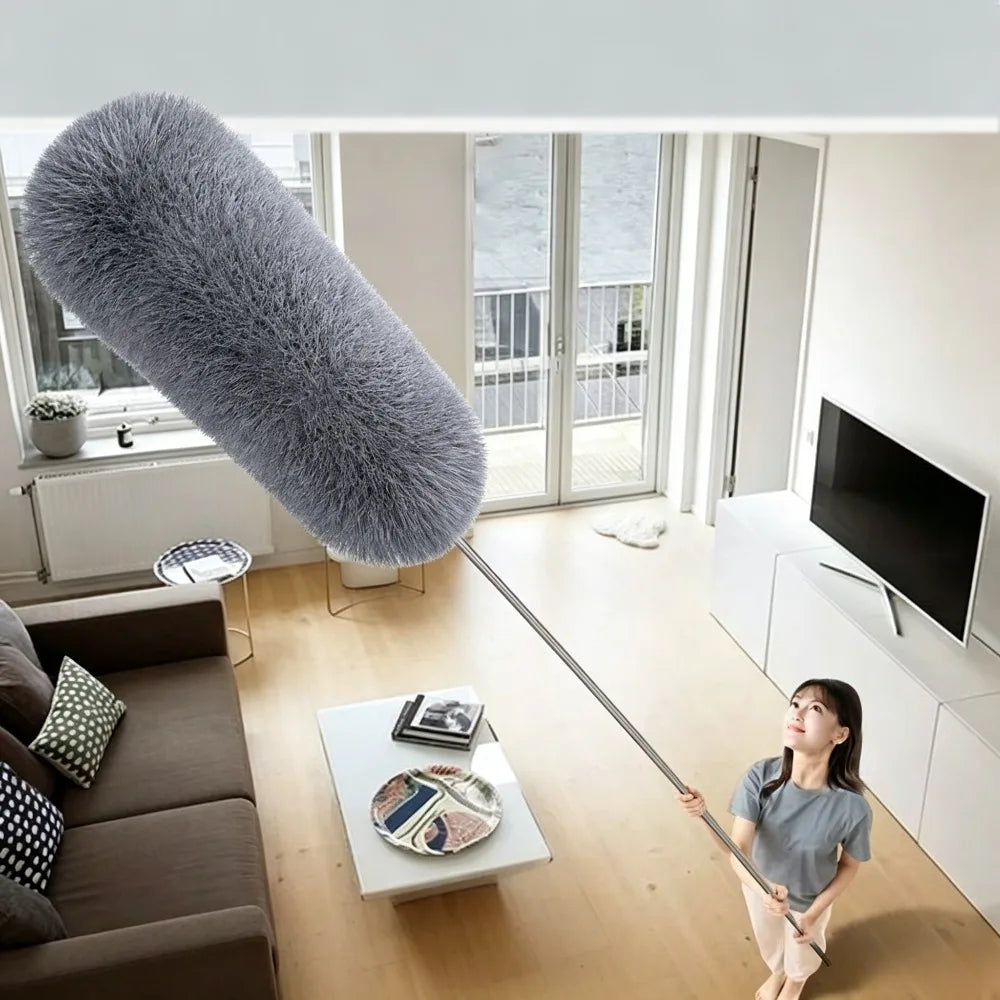 A woman holds an extendable microfiber duster with an adjustable handle in a bright room.
