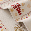 Close-up of a cream knitted fabric with red and gold snowflake patterns, showing a folded edge.
