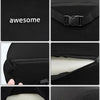Close-up details of a black memory foam car headrest and lumbar support pillow showing texture and stitching.