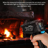 A hand holds a black digital infrared thermometer with a red alarm light, measuring temperature near a fireplace.