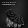 A black ergonomic 3D motorcycle seat cushion with elastic shock absorption features resting on a metal spring base.