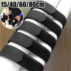 Black reusable nylon cable ties with adjustable hook and loop fasteners shown on a white cylindrical object.