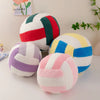 A collection of colorful simulation volleyball plush toys and pillows in various striped patterns.