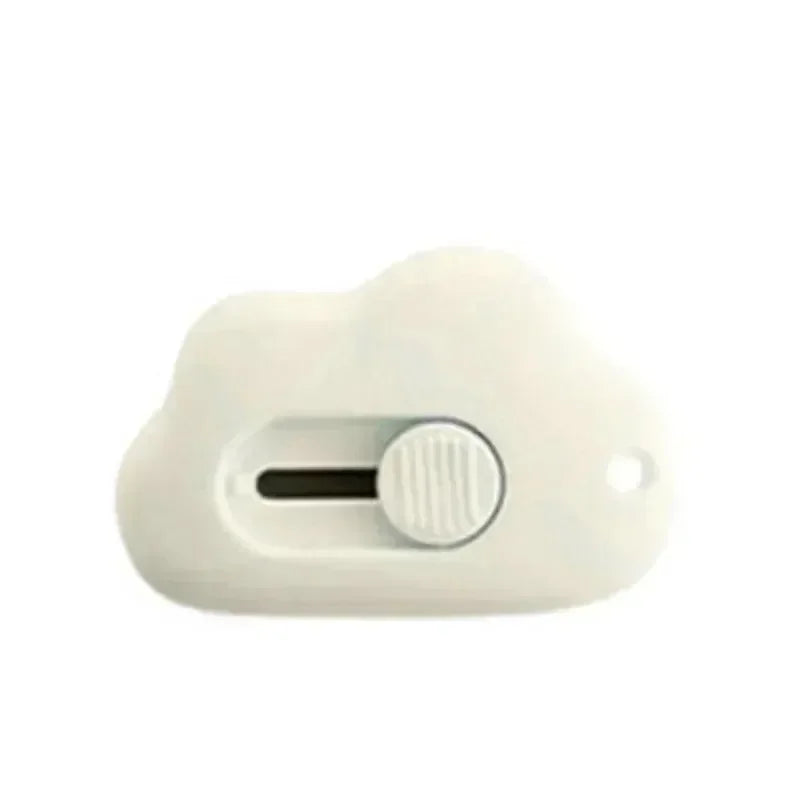 A white compact mini cutter with a retractable blade and a round button.