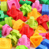 A collection of colorful plastic screw and nut building blocks for kids in various shades of pink, green, orange, and red.