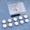 A clear plastic bag contains a kit of instant no-sew snap buttons and various round buttons on a blue denim background.
