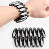 A set of black magnetic fidget balls arranged in a row on a white background.