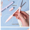 A hand holds a pink pen-shaped tool that functions as both scissors and a paper knife.