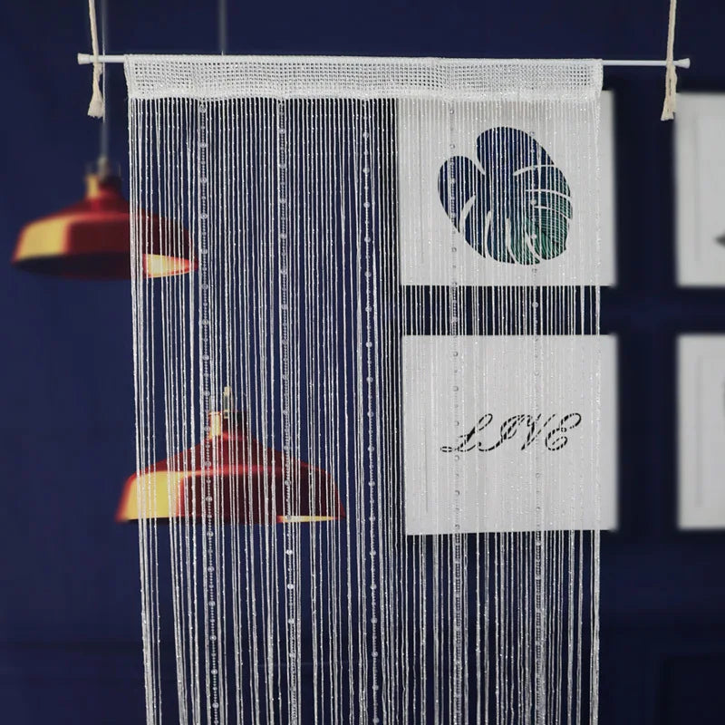 A white beaded string curtain hangs, featuring a heart design and the word LOVE.