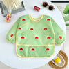 A light green waterproof long-sleeve baby feeding smock decorated with red sun shapes.