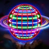 A hand is holding a glowing, spherical LED ball that emits vibrant light rings and stripes.