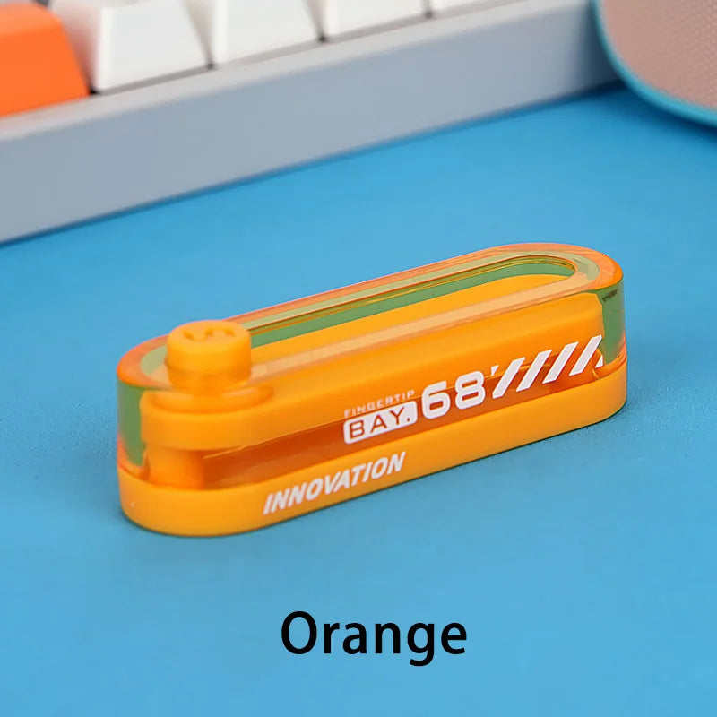 An orange metal fidget slider with a green accent is shown on a blue surface.