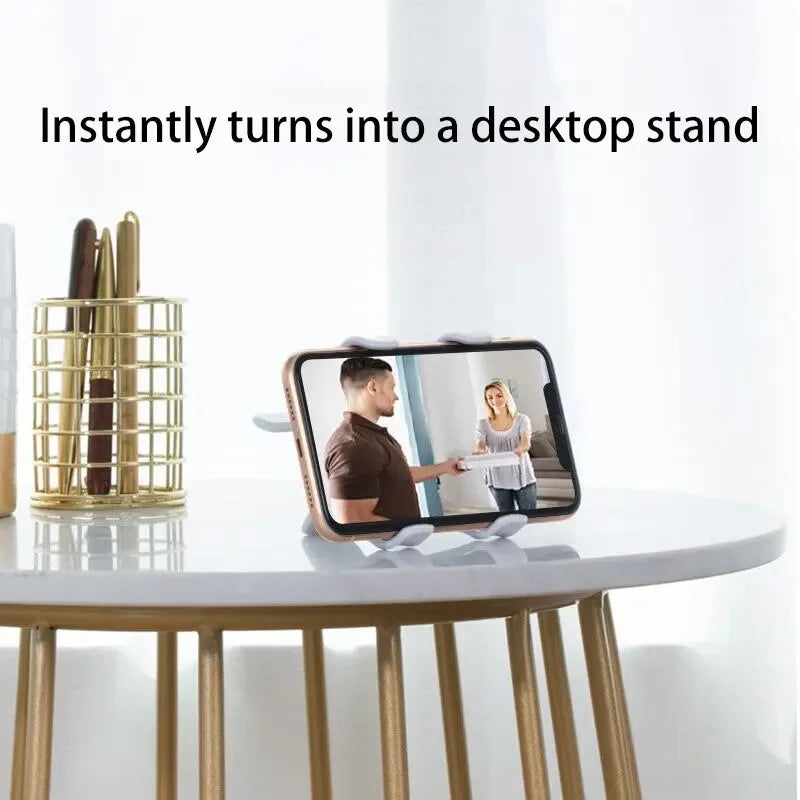 A smartphone is mounted on a gold-colored stand, transforming into a desktop stand.