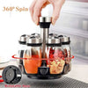 A hand rotates a set of glass spice jars on a rotating base for seasoning.