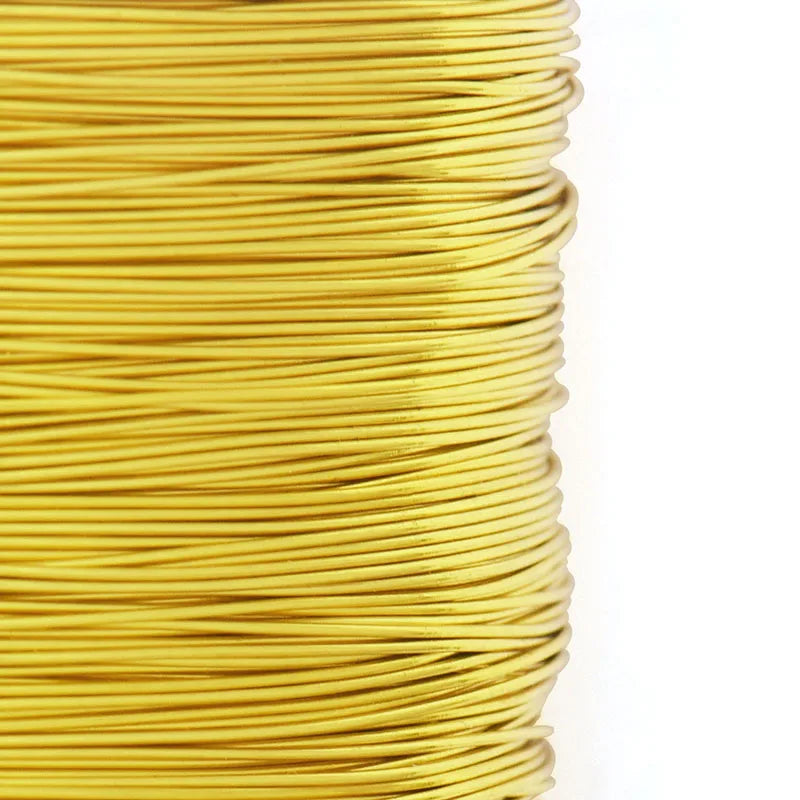 A spool of bright yellow copper clad steel sculpting wire used for craft and jewelry making.