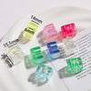 A collection of colorful acrylic alphabet beads displayed on a white plate with measurement lines.