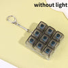 A clear plastic fidget toy keychain with multiple dark blue LED keycaps and a silver keyring.