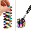 A hand holds a set of iridescent magnetic fidget balls with a black storage case and several loose balls.
