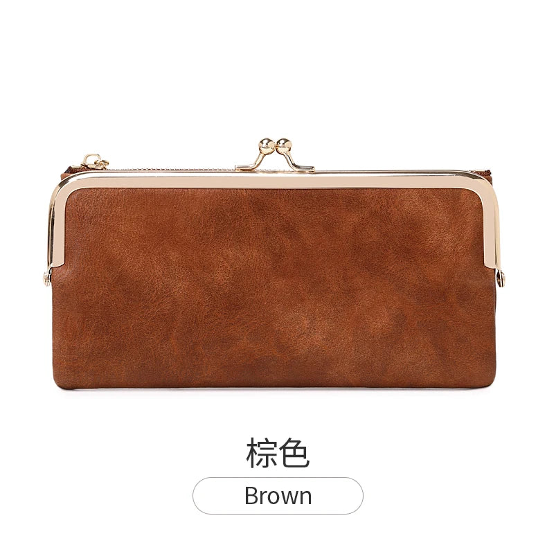 A brown vintage kiss lock long wallet for women shown against a white background.