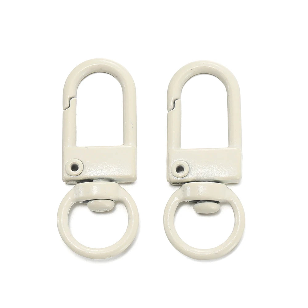 A pair of light beige alloy lobster clasp hooks for DIY jewelry making.