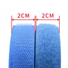 Rolls of blue sew-on hook and loop tape with measurement lines indicating 2cm sections.