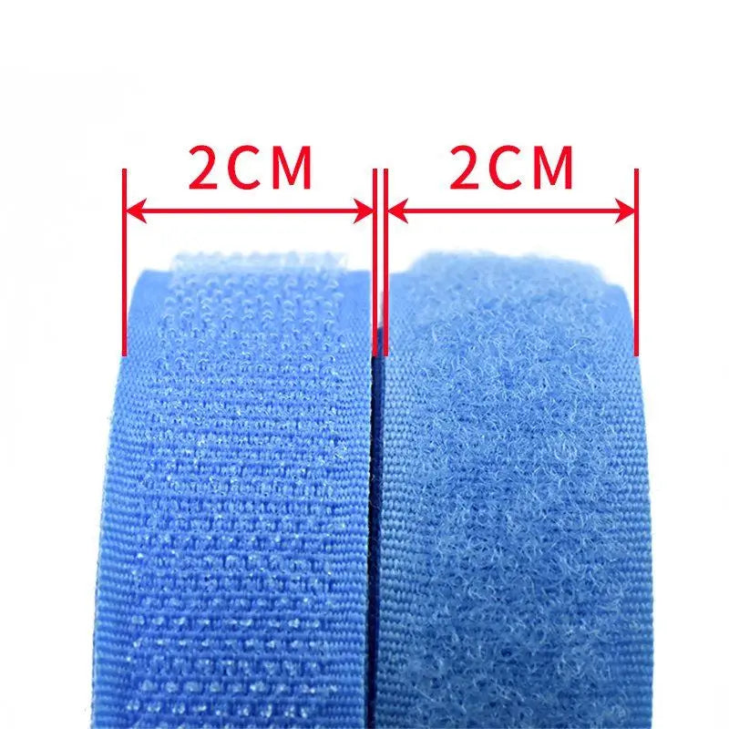Rolls of blue sew-on hook and loop tape with measurement lines indicating 2cm sections.