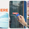 A hand uses a blue plastic scraper to clean a window, next to a wooden scraper and a green scraper.