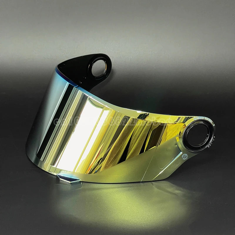A clear replacement motorcycle helmet visor reflecting light on a dark surface.