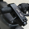 A close-up view of a black QPS lock with a textured handle, designed for securing bikes and scooters.