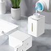 A white touchless soap dispenser is shown next to various liquid soaps and detergents on a marble surface.