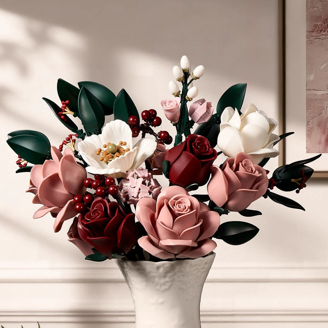 A bouquet of pink and white roses with dark green leaves arranged in a white vase.