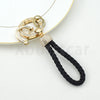 Gold and diamond-encrusted TPU key fob cover with a black cord strap